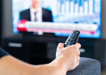 A stock image of a person watching election coverage