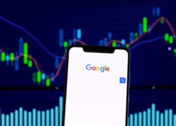Stock photo of Google in front of financial charts