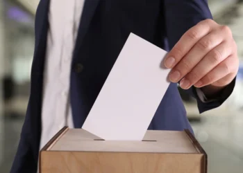 Stock photo of a man casting a ballot on Election Day
